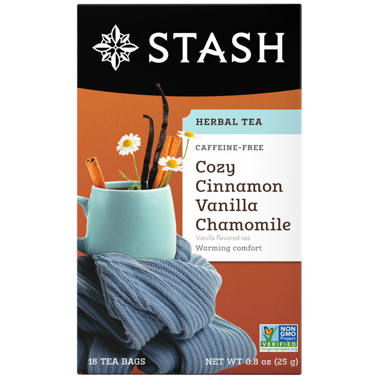 Stash Cozy Cinnamon Vanilla Chamomile tea package with a cup and chamomile flowers on an orange background.