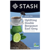 Stash tea package with a cup of tea, lime, and bergamot on a blue background