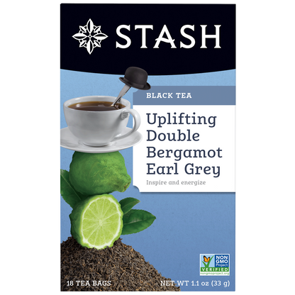 Stash tea package with a cup of tea, lime, and bergamot on a blue background