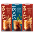 Three STASH coffee concentrate cartons shown side by side on a white background: Double Spice Chai Latte in red, Earl's Delight Latte in blue, and Double Spice Chai Latte in red. Each carton includes a glass of iced coffee with cinnamon sticks and a lemon slice graphic.