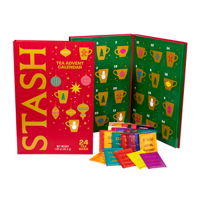 Stash Tea Advent Calendar with 24 tea bags, showing the red outer box, the green numbered advent calendar panel, and several colorful individual tea bag packets in front on a white background.
