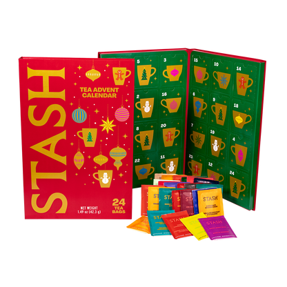 Stash Tea Advent Calendar with 24 tea bags, showing the red outer box, the green numbered advent calendar panel, and several colorful individual tea bag packets in front on a white background.