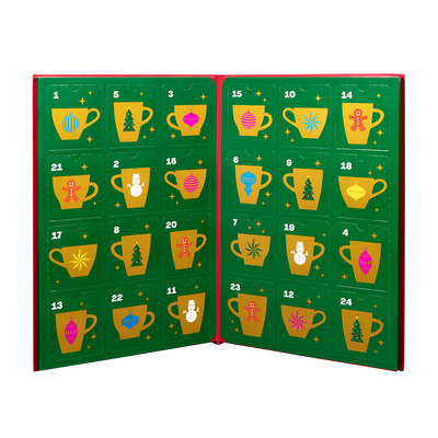 An open advent calendar with 24 numbered green panels, each decorated with a colorful holiday mug illustration and a red spine.