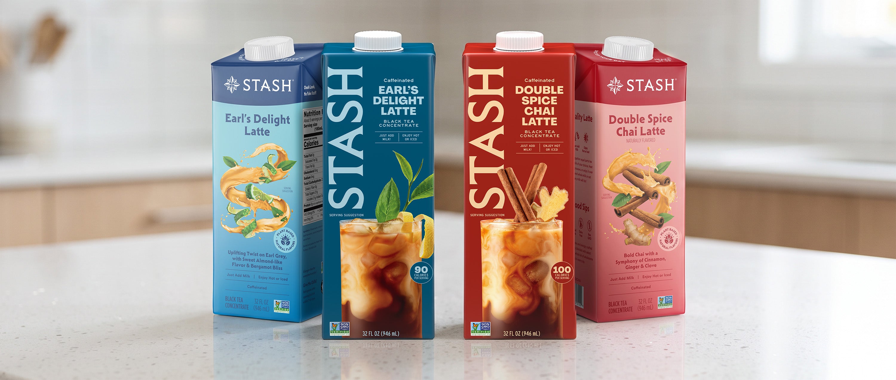 Four Stash beverage cartons standing on a light countertop in a kitchen setting: Earl's Delight Latte, Earl's Delicious Latte, Double Spice Oat Latte, and Double Spice Chai Latte.