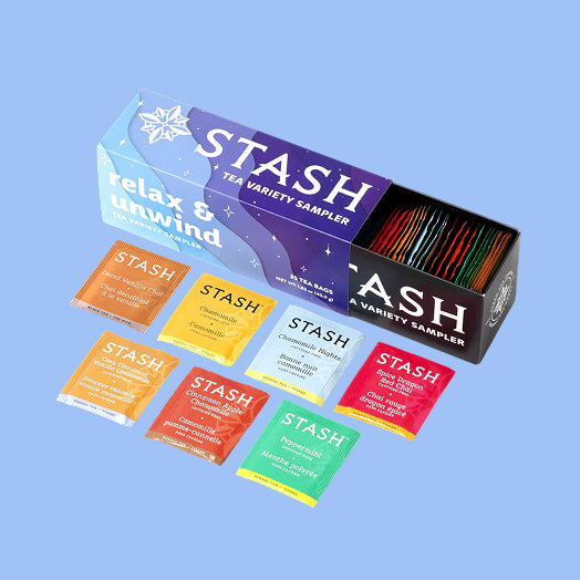 Stash tea sampler box with assorted tea bags on a blue background