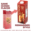 A comparison graphic showing two Stash Double Spice Chai Latte cartons on a white background, with text reading 'SAME ICONIC FLAVOR' and 'REIMAGINED STYLE.' The left carton is a smaller pinkish-red version, and the right carton is a taller red version with a white cap and a printed beverage image on the front.