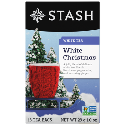 Stash White Christmas white tea packaging with a red knitted blanket and snow-covered trees.