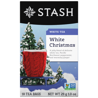 Stash White Christmas white tea packaging with a red knitted blanket and snow-covered trees.