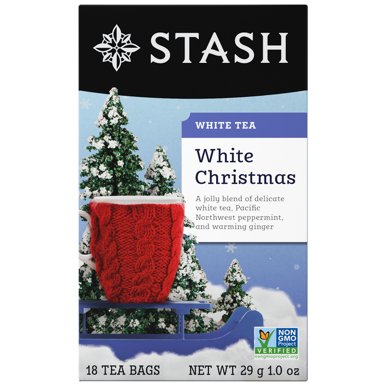 Stash White Christmas white tea packaging with a red knitted blanket and snow-covered trees.